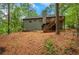A tree-filled backyard with a sloped hill and trees in background at 4788 Rock Island Nw Ln, Acworth, GA 30102