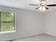 Neutral bedroom features a ceiling fan and a large window bringing in plenty of natural light at 4788 Rock Island Nw Ln, Acworth, GA 30102