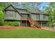 Split-level home with an olive exterior, deck, two-car garage, and green lawn at 4788 Rock Island Nw Ln, Acworth, GA 30102