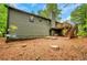 Exterior of the home featuring a wooden deck, a chimney, and wooded backyard at 4788 Rock Island Nw Ln, Acworth, GA 30102