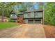 Two-story home with well-manicured lawn, attached two-car garage and wood porch at 4788 Rock Island Nw Ln, Acworth, GA 30102