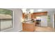 Well-lit kitchen features wood cabinets, stone countertops, modern appliances, and wood floors at 4788 Rock Island Nw Ln, Acworth, GA 30102