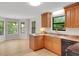 Eat-in kitchen featuring wood cabinets, black appliances, and neutral countertops at 4788 Rock Island Nw Ln, Acworth, GA 30102