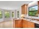 Eat-in kitchen featuring wood cabinets, black appliances, and neutral countertops at 4788 Rock Island Nw Ln, Acworth, GA 30102