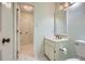 Neutral bathroom features a vanity and mirror, as well as a tiled shower at 12 Westchester Square Sq, Decatur, GA 30030
