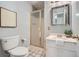 Cozy bathroom featuring a stand-up shower with glass door, a toilet, and a marble top sink at 12 Westchester Square Sq, Decatur, GA 30030