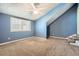 Bedroom with blue walls, carpet, stairs, a ceiling fan, and a large window at 12 Westchester Square Sq, Decatur, GA 30030