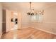 Open dining room with hardwood floors, chandelier, and doorway view of the kitchen at 12 Westchester Square Sq, Decatur, GA 30030