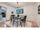 Elegant dining room featuring hardwood floors, a modern chandelier, and a view into the kitchen at 12 Westchester Square Sq, Decatur, GA 30030