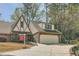 Charming Tudor-style home featuring a two-car garage, brick facade, and well-manicured landscaping at 12 Westchester Square Sq, Decatur, GA 30030