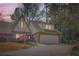 Inviting exterior view of a two-story Tudor home with a brick facade, two-car garage, and lush landscaping at 12 Westchester Square Sq, Decatur, GA 30030