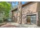 Backyard view showing brick and siding details with mature trees at 12 Westchester Square Sq, Decatur, GA 30030