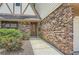 Brick home exterior with wood door, walkway, and manicured shrubs at 12 Westchester Square Sq, Decatur, GA 30030