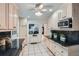 Open kitchen with wooden cabinets, black countertop, stainless steel appliances, and tile flooring at 12 Westchester Square Sq, Decatur, GA 30030