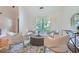 Bright sitting area with four upholstered chairs, neutral color palette, and a large window at 12 Westchester Square Sq, Decatur, GA 30030