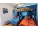 Bedroom featuring bunk beds with blue accent wall, ceiling fan and stuffed animals at 150 Newton Ridge Dr, Covington, GA 30014