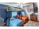 Bedroom featuring bunk beds with blue accent wall, ceiling fan, hardwood floors and tv at 150 Newton Ridge Dr, Covington, GA 30014