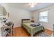 Cozy bedroom with a comfortable bed, wooden floors, and ample natural light from the window at 150 Newton Ridge Dr, Covington, GA 30014