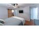 Bedroom with hardwood floors, ceiling fan and closet with sliding barn door at 150 Newton Ridge Dr, Covington, GA 30014