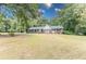 A large front yard with mature trees, plenty of parking, and welcoming curb appeal at 150 Newton Ridge Dr, Covington, GA 30014