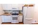 Efficient kitchen featuring white appliances and cabinets, providing a clean and functional cooking space at 150 Newton Ridge Dr, Covington, GA 30014