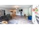 Spacious living room with hardwood floors, tv, blue chair, and grey couch at 150 Newton Ridge Dr, Covington, GA 30014