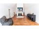 Open living room with a fireplace, piano, and gray recliner, seamlessly blending comfort and elegance at 150 Newton Ridge Dr, Covington, GA 30014