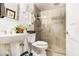 Modern bathroom featuring a glass enclosed shower, pedestal sink, and tiled walls at 1534 September Chase, Decatur, GA 30033