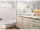 Comfortable bathroom featuring a tub-shower, granite counters, and decorative wall lamps at 1534 September Chase, Decatur, GA 30033
