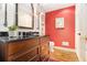 Charming powder room with dark wood vanity, granite top, and red accent wall at 1534 September Chase, Decatur, GA 30033