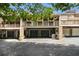 Townhome garages with upper patios and brick columns under shade trees at 1534 September Chase, Decatur, GA 30033