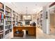 Spacious home office with custom bookshelves, neutral wall colors, and tile flooring at 1534 September Chase, Decatur, GA 30033