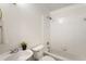 Bright bathroom with a white sink, toilet, and a tiled shower-tub at 1634 Ponce De Leon Ave # 107, Atlanta, GA 30307