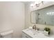 Modern bathroom features marble-look tile in shower, brushed gold fixtures, and stylish lighting above vanity at 1634 Ponce De Leon Ave # 107, Atlanta, GA 30307