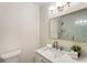 Modern bathroom featuring vanity with stone countertop, a mirror, and contemporary lighting fixtures at 1634 Ponce De Leon Ave # 107, Atlanta, GA 30307