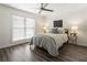 Cozy bedroom featuring luxury vinyl plank flooring, a ceiling fan, and a large window for lots of natural light at 1634 Ponce De Leon Ave # 107, Atlanta, GA 30307