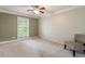Inviting bedroom with neutral tones, plush carpeting, chair, and window offering natural light at 1634 Ponce De Leon Ave # 107, Atlanta, GA 30307