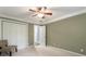 Spacious bedroom with plush carpeting, closet, chair, and olive green walls creating a calming atmosphere at 1634 Ponce De Leon Ave # 107, Atlanta, GA 30307