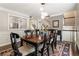 Elegant dining room featuring a stylish chandelier, hardwood floors, and a view into the kitchen at 1634 Ponce De Leon Ave # 107, Atlanta, GA 30307