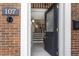 Inviting entryway featuring a black front door with glass and a glimpse of the home's interior at 1634 Ponce De Leon Ave # 107, Atlanta, GA 30307