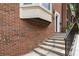 Brick home showcasing a side view of the entry stairs and landscaping at 1634 Ponce De Leon Ave # 107, Atlanta, GA 30307