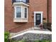 Charming brick home featuring a bay window, black door, and inviting front entrance with manicured landscaping at 1634 Ponce De Leon Ave # 107, Atlanta, GA 30307