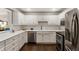 Modern kitchen with stainless steel appliances, white countertops, and dark hardwood floors at 1634 Ponce De Leon Ave # 107, Atlanta, GA 30307