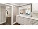 Bright kitchen features white cabinets, hardwood floors, and a pass-through to the dining area at 1634 Ponce De Leon Ave # 107, Atlanta, GA 30307