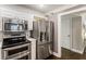 The kitchen includes stainless steel appliances, modern cabinets, and adjacent access to a hallway with a door at 1634 Ponce De Leon Ave # 107, Atlanta, GA 30307