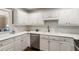 This kitchen features sleek, stainless steel appliances, white cabinets and backsplash, and ample counter space at 1634 Ponce De Leon Ave # 107, Atlanta, GA 30307