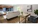 A living room view offers ample seating, a workspace with desk, and entertainment center in the background at 1634 Ponce De Leon Ave # 107, Atlanta, GA 30307