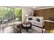 Living room with access to an outdoor balcony, hardwood floors, modern furnishings, and a stylish rug at 1634 Ponce De Leon Ave # 107, Atlanta, GA 30307