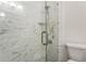 Contemporary shower features a glass door, white marble-patterned tile, and built-in shelving at 1634 Ponce De Leon Ave # 107, Atlanta, GA 30307
