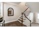 Elegant staircase with hardwood steps, white risers, and a classic banister adds charm to the entryway at 1634 Ponce De Leon Ave # 107, Atlanta, GA 30307